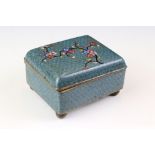 An ornate decorative Cloisonné trinket box with lotus blossom decoration.