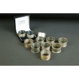 Collection of 11 silver napkin rings to include a set of three Victorian examples with floral