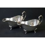Pair of Queen Elizabeth II silver gravy boats, of typical plain polished form, with scrolled