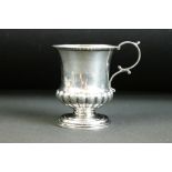 Early 19th century silver tankard with gadrooned decoration above a circular pedestal base, scrolled