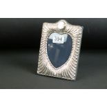 Silver heart-form rectangular photo frame with gadrooned design and vacant cartouche, easel back,
