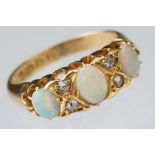 Early 20th century opal and diamond 18ct yellow gold ring, three graduated oval cabochon cut