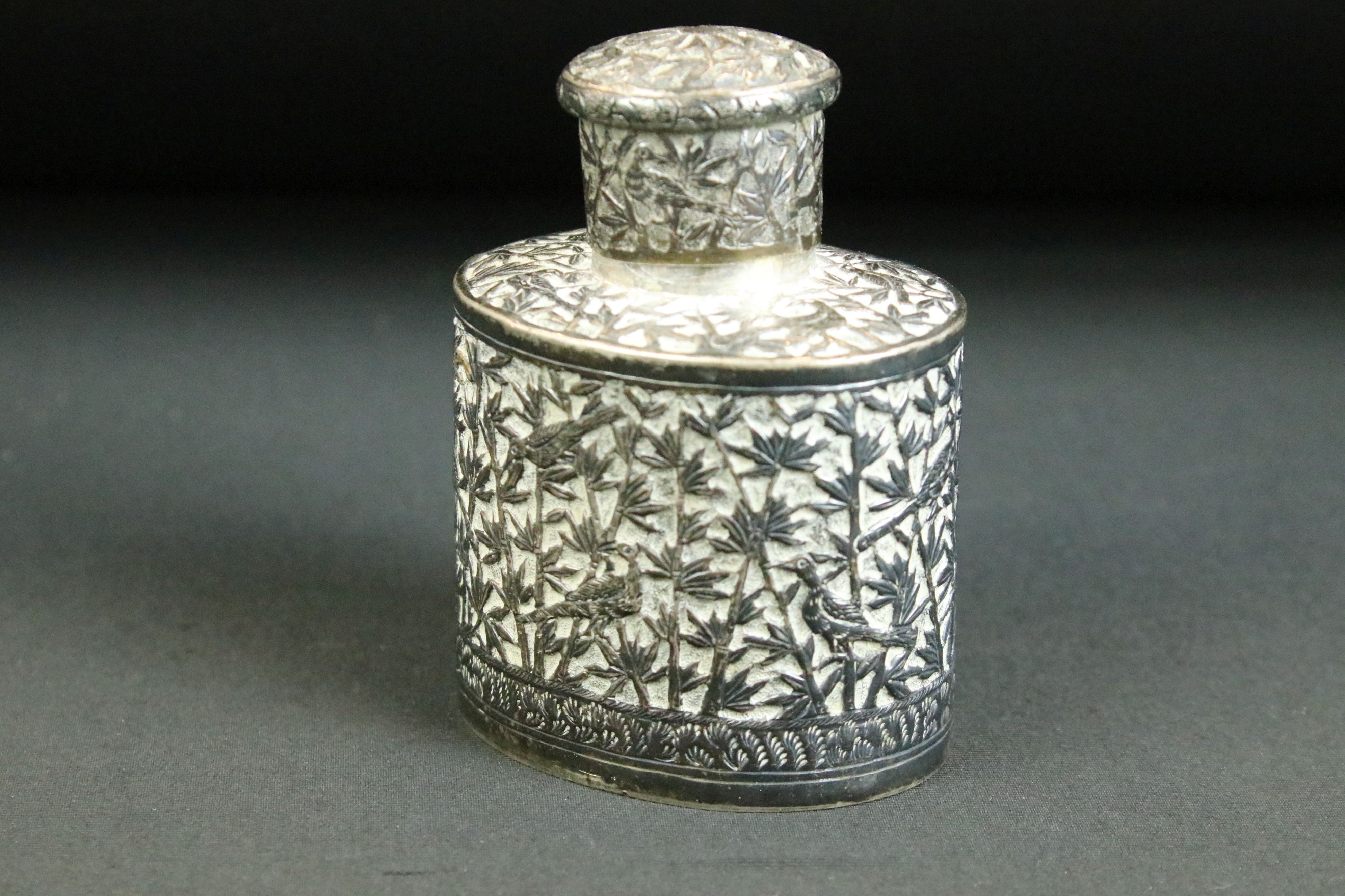 20th Century Chinese white metal tea caddy of oval form having moulded detailing to the sides