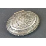 Middle Eastern / Indian white metal oval snuff box, repoussé phoenix to the centre, dimensions