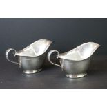 Pair of George VI silver gravy boats of typical plain polished form, with moulded upper rims,