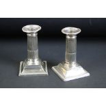 Pair of early 20th century silver Corinthian column candlesticks, the removable sconces with