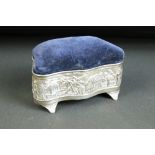 Early 20th century silver sewing box with pin cushion to lid, repousse decorated with tropical