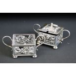 Edwardian silver lidded mustard pot and salt cellar, the pierced borders with scrolling foliate