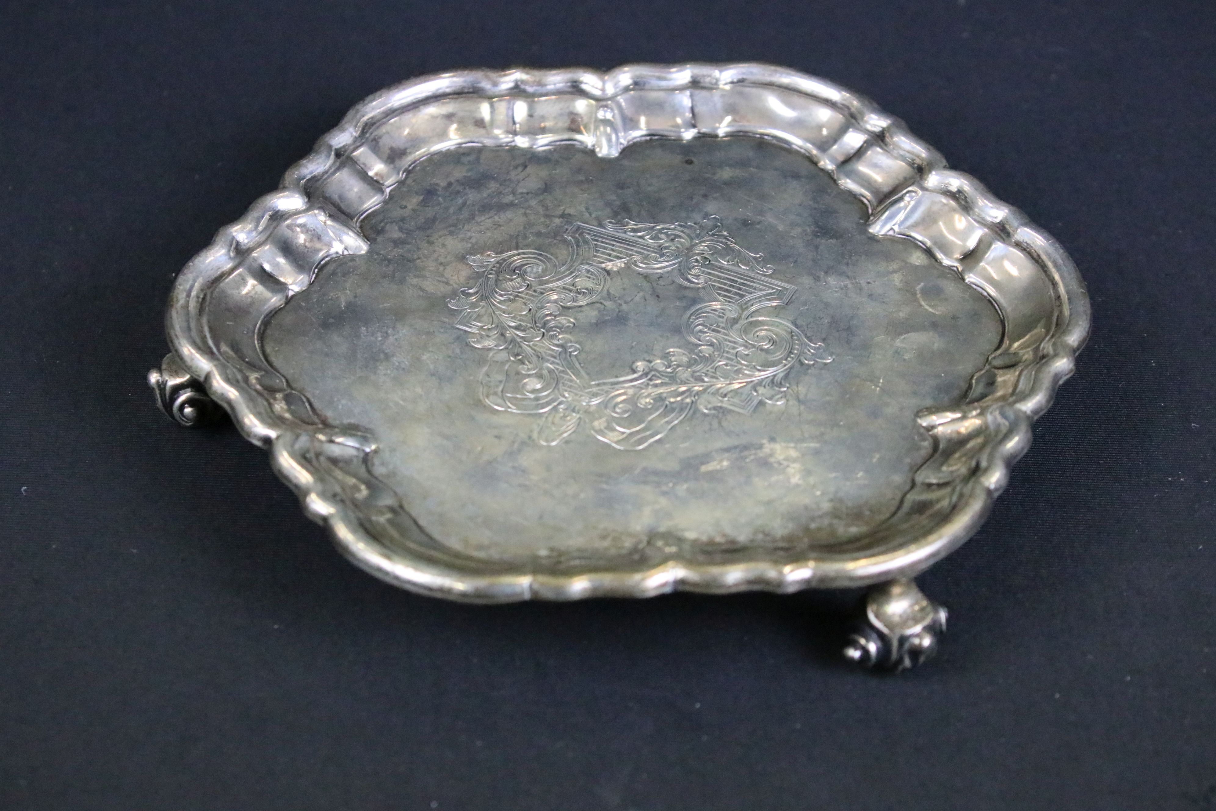 William Hutton & Sons silver salver having a moulded rim with engraved crest raised on scrolled