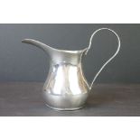 Iraqi white metal jug, plain polished baluster form, elongated lip, C-shape handle, height approx