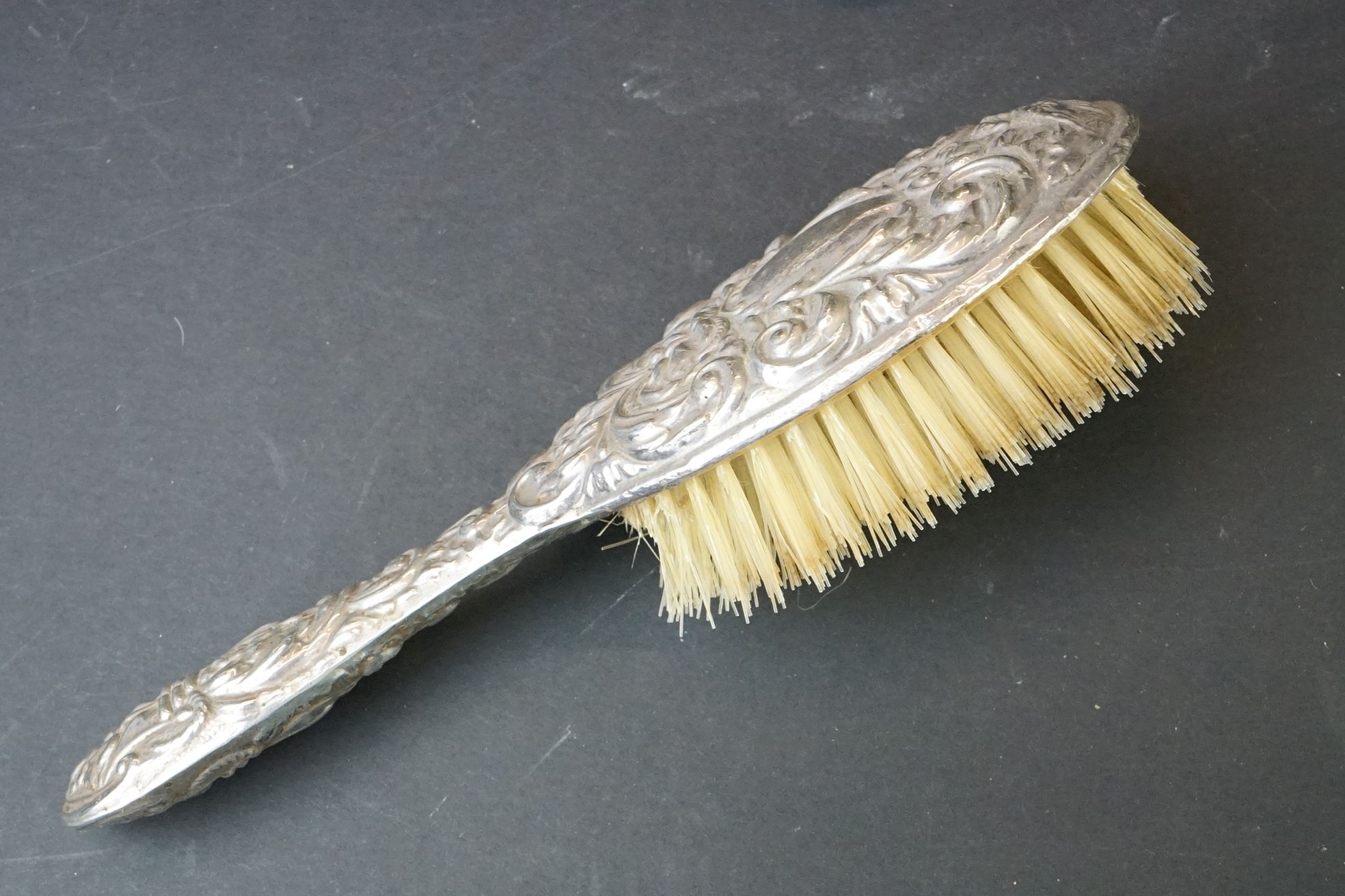 Mid 20th C silver mounted four-piece dressing table brush set with repousse Gothic-style decoration, - Image 3 of 7