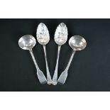 Two silver berry spoons with gilt bowls and matching design with floral engraving to handles, to