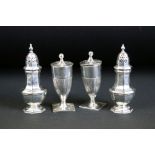 Two pairs of silver hallmarked salt and pepper shakers. The lot to include a pair of Horace Woodward