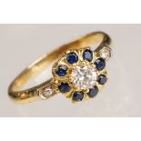 Diamond and sapphire cluster ring, the round brilliant cut diamond weighing approx 0.40 carat,