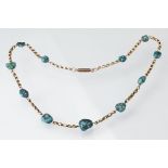 Early 20th century turquoise and yellow metal necklace, eleven asymmetric rough turquoise beads,