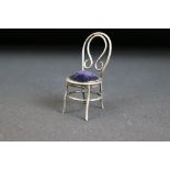 Victorian silver hallmarked pin cushion in the form of a chair with a blue velvet cushion.