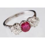 Ruby and diamond 18ct white gold three stone ring, the oval mixed cut ruby measuring approx 6mm x