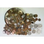 A small collection of British pre decimal and foreign coins to include commemorative examples.