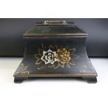 A sarcophagus shaped black wooden box with hand painted decoration and velvet lined interior. Approx