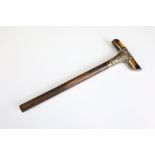 An antique parasol or walking stick handle, tigers eye cross handle with hallmarked 15ct gold