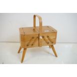 Mid century Beech wood Concertina Sewing Box with carry handle and raised on four turned legs,