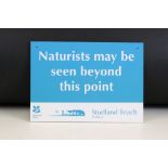 A National Trust "Naturists may be seen beyond this point" warning sign from Studland beach.