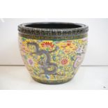 Chinese yellow ground jardiniere, with enamel decoration depicting dragons amongst scrolling