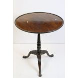 George III Mahogany Circular Dish Top Table, raised on a turned pedestal support with three swept