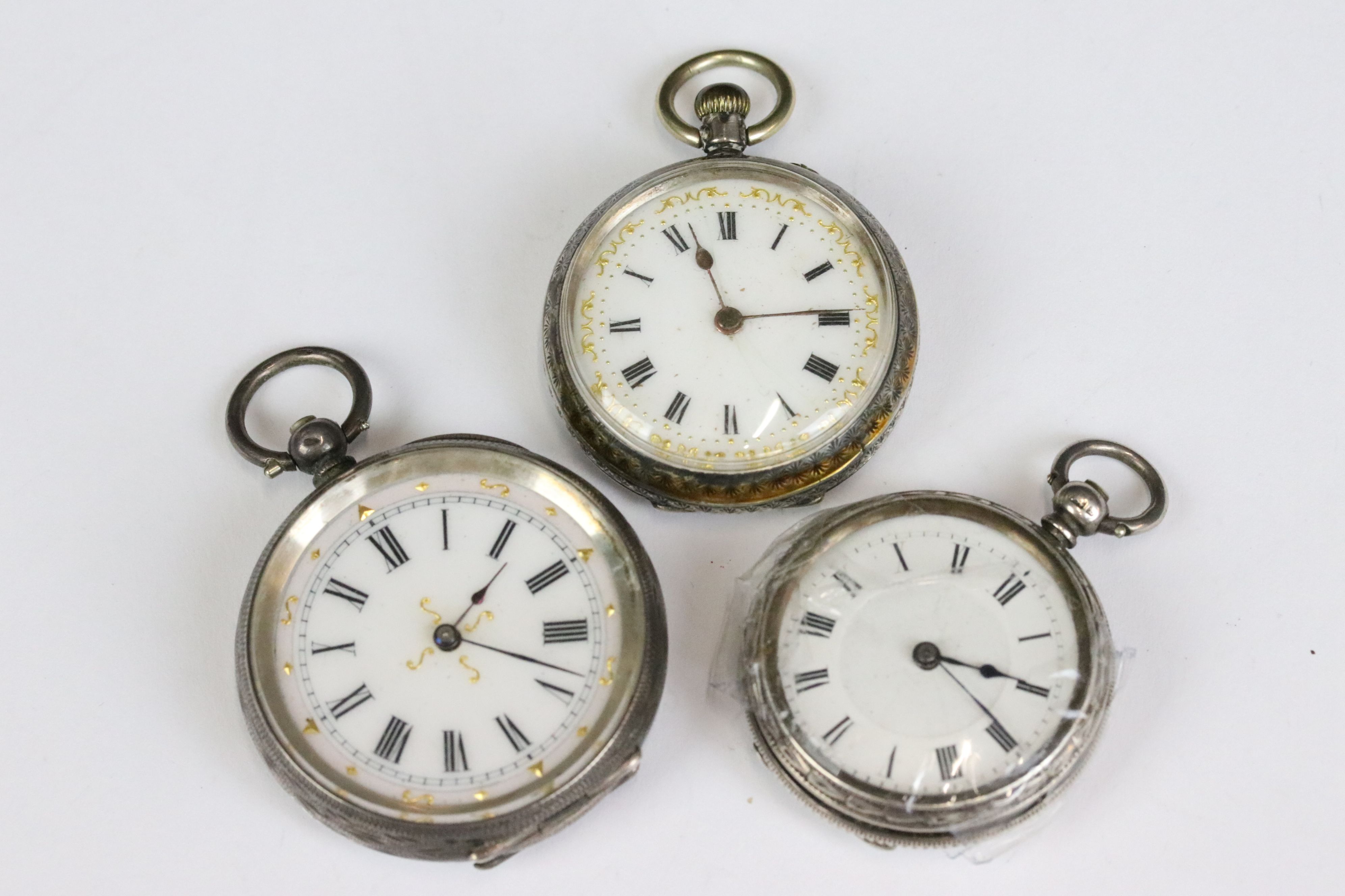 A collection of three silver cased ladies fob watches, two with enamel decoration to the dial.