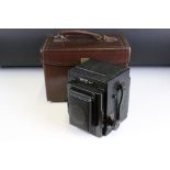 A early to mid 20th century large format camera together with lens, filters...etc and stored