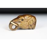 A brass vesta case in the form of an elephant with inlaid eyes, measures approx 5cm in length.