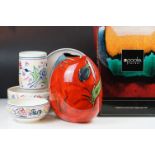 Poole Pottery - A red ground floral purse vase (25.5cm high) and four pieces with typical floral