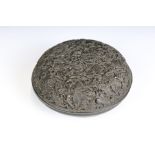An oriental decoratively carved wooden circular trinket box with butterfly decoration.