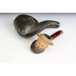 An antique meerschaum pipe with the bowl carved as a gentleman wearing a hat, silver collar and