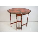Early 20th century Japanned Red Lacquered Small Gate-leg Table, the shaped oval top with chinoiserie