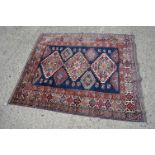 Eastern Red and Blue Ground Wool Rug decorated with six guls within a deep border, approx. 151cm x