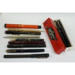 A collection of ballpoint and fountain pens to include Parker and Waterman examples.