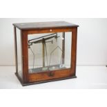 A set of early 20th century scales by Griffin & Tatlock Ltd within glass case.