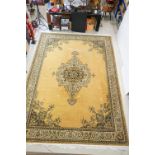 Large Mustard Ground Rug decorated with a central floral panel within a border, 297cm x 411cm