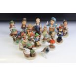 Fourteen Hummel Goebel figurines to include a postman, boy with lamb, flute player etc. Tallest