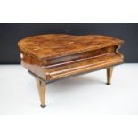 Mid Century walnut music box in the form of a piano. The box having compartment to the front with