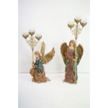 Two composite resin figures tea light holders in the form of angels.