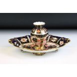 Two pieces of Royal Crown Derby ceramics to include an oval dish and a small vase. Both decorated in