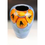 Poole Pottery - Wild Poppy - A drip glaze vase having a blue ground with an orange floral spray to