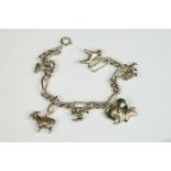 A sterling silver charm bracelet together with six charms in the form of different animals.