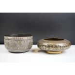 An antique asian copper bowl with silvered relief decoration together with a brass example.