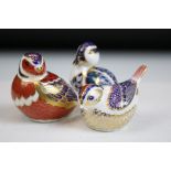 Group of three Royal Crown Derby ceramic paperweights to include two birds with gold stoppers and