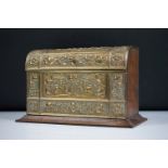 An early 20th century wooden letter rack with brass art nouveau repousse decoration.