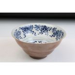 Chinese 19th Century blue and white porcelain bowl being hand painted with floral and precious