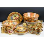 Baroness china dinner service featuring painted peach and grape motifs and gilt rims. Signed A